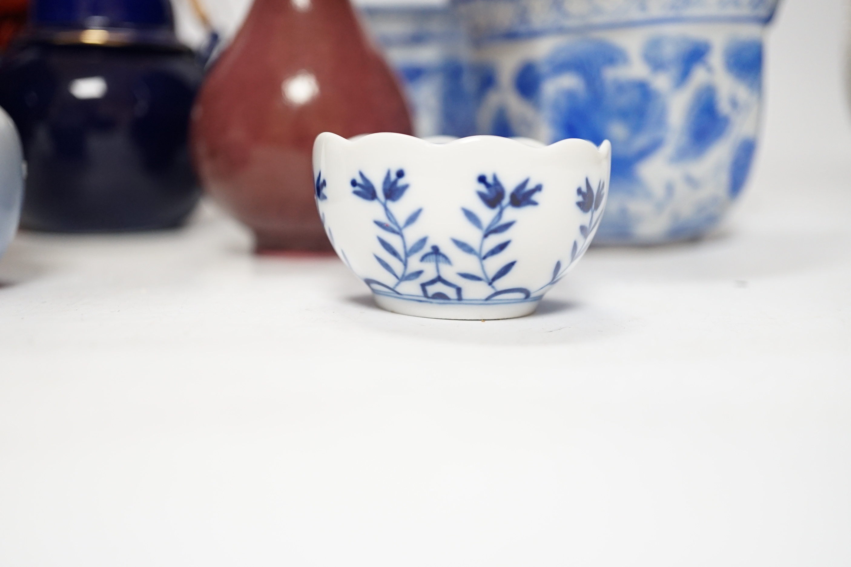 A Chinese cinnabar lacquer jar and cover, a Chinese copper red bottle vase, a carved wood figure, a Meissen miniature bowl and other ceramics, jar 15cm